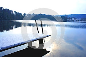 Footbridge with snow with finter lake