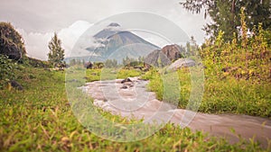 Foothills of the Mayon Volcano with flowing mountain rivers near Legazpi city in Philippines. Mayon Volcano is an active photo