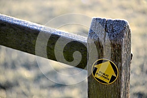 Footpath arrow on oak post