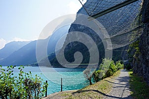 Footpath near rock and Lucerne lake, Switzerland