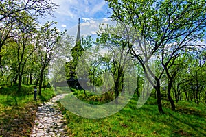 Footpath to traditional Maramures wooden church. UNESCO world heritage site. Barsana, Romania