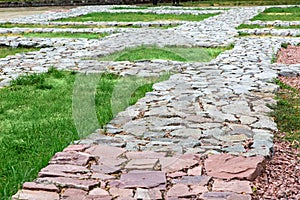 Footpaths made of natural rough stone. photo