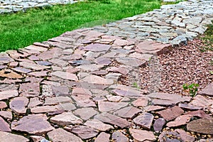 Footpaths made of natural rough stone. photo