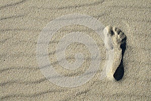Footprint on beach sand texture with ripples