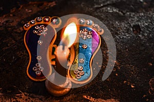 Footprint of god on indian festival diwali deepawali with fire isolated on table