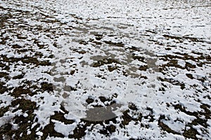 Footprint of a human in the snow in mountains after Winter in Spring