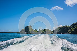 Footprint from a motor boat on the water in the tropics. Motorboat ride in blue water, footprints of water from speed boat