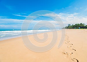 Footprint on sea beach blue sky sand sun daylight relaxation landscape viewpoint for design postcard and calendar in Phuket, thail
