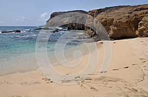 Footprints, beach and cliff