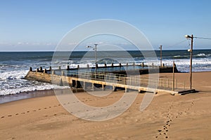 Footprints in Beach Sand Leading to Tidal Pool