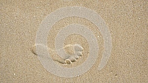 Footprints on the beach sand, Surface of human footmarks on smooth sand at the seaside, In summer, Texture background.