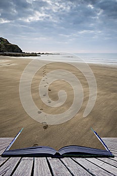 Footprints on beach Summer sunset landscape conceptual book image