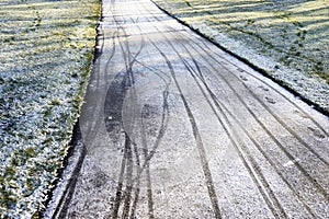 Footprints and bicycle tracks on the track covered with the first snow
