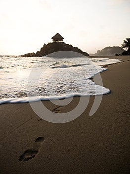 Footprints at Cabo San Juan del Guia sand beach wave in Tayrona National Park tropical Caribbean Colombia South America