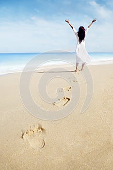Footprints and carefree woman