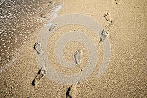 Footprints deep in the sand, optical Illusion photo