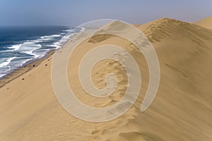 footprints on dune edge at Atlantic shore near Sandwich Harbour, Namibia