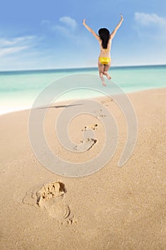 Footprints and excited woman jumping 1