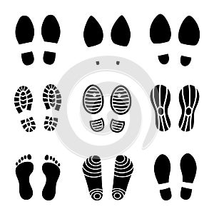 Footprints. Human boot footsteps, shoes funny contour. Vector black footsteps silhouettes isolated on white photo