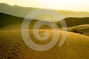 Footprints in desert dunes of Death Valley National park. Landscape image embodying self discover and perseverance.