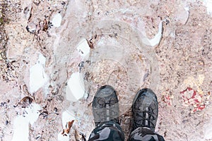 Footprints of people in clayey ground and the man`s feet