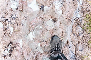 Footprints of people in clayey ground and the man`s feet