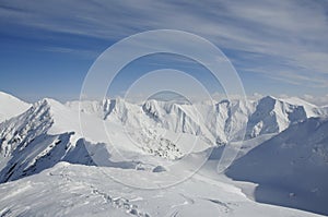 Footprints on ridge of snow capped mountain