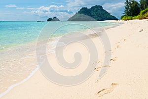 footprints in the sand along the sea on Poda island