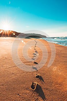 Footprints in Sand on Australian Beach at Sunrise