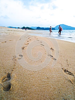 Footprints in the sand on the beach