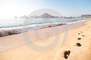 Footprints in the sand on the beach in Cabo San Lucas.