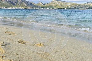 Footprints in the sand of a beach by the Mediterranean sea on th