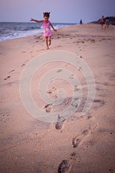 Footprints in the sand from children`s feet.