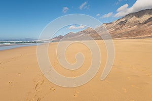 Footprints in sand on Cofete beach, Fuerteventura island