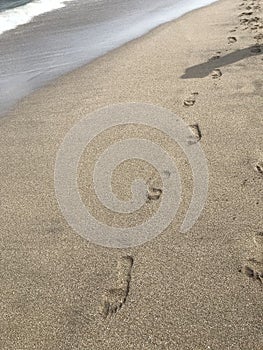 Footprints in the sand at the seashore