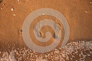 Footprints on sand texture beach ground and sea side wave water top view outside background wallpaper pattern summer time space