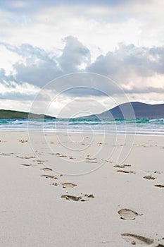 Footprints in the sand, turquise water and impressive skyes, Luskentyre, Isle of Harris, Scotland photo