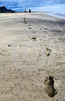 Footprints in the sand. Walking on the beach.