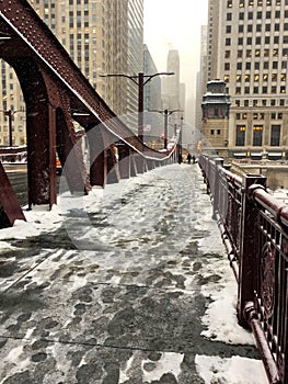 Footprints on snow covered bridge across the Lasalle Street bridge in Chicago Loop