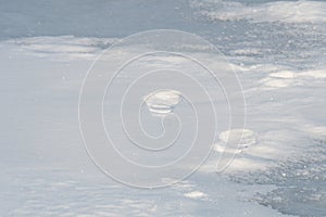 Footprints in the snow on frozen lake