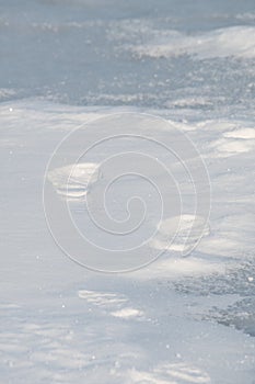 Footprints in the snow on frozen lake