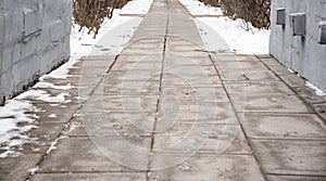 Footprints on snowy sidewalk, first snow of the year