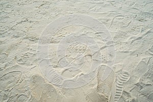Footprints on soft sand at beach