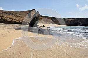 Footprints to an erected beach boulder