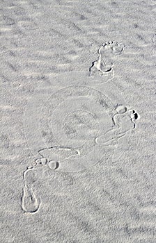 Footprints on white sand