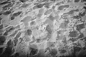 Footprints on a white sand beach