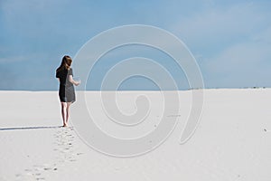 Footprints of woman walk with aquarium in desert