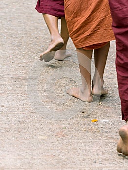 Foots of ascetic Buddhist monk walking