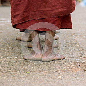 Foots of ascetic Buddhist monk walking photo