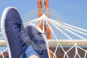 Foots of man in hammock. Relaxation and recration on vacation